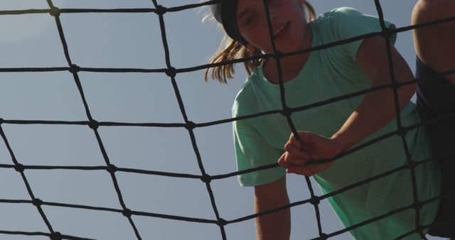 Child Climbing Rope Net on Summer Day Against Clear Sky - Download Free Stock Images Pikwizard.com