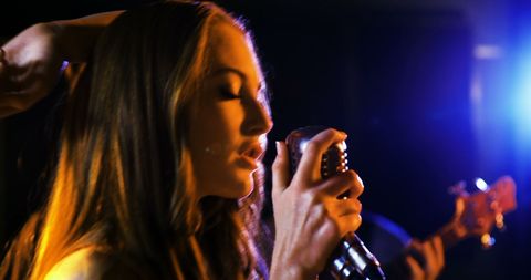 Dynamic Female Singer Performing Live Under Vibrant Stage Lights - Download Free Stock Images Pikwizard.com