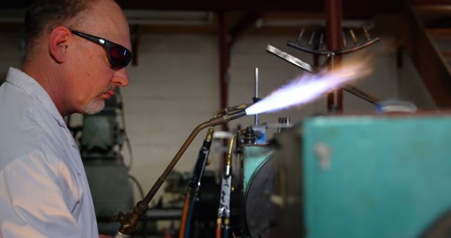 Male Industrial Worker Using Blowtorch in Workshop - Download Free Stock Images Pikwizard.com