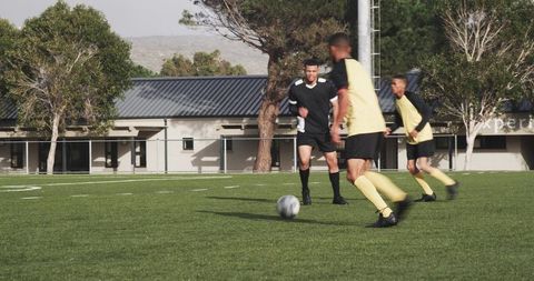 Soccer players in action on field during competitive match