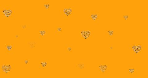 Fluttering Heart-Shaped Flowers on Bright Orange