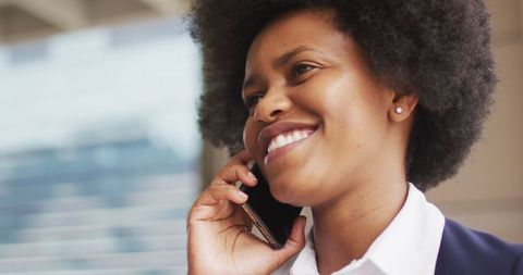 Confident Businesswoman Smiling While Using Smartphone Outdoors
