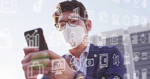 Businessman Wearing Mask Using Smartphone with Analytics Icons Overlay
