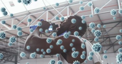 Athlete drinking from bottle and face mask with floating virus illustration