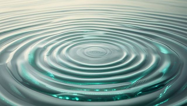 Concentric Ripples on Calm Teal Water Creating Hypnotic Wave Patterns