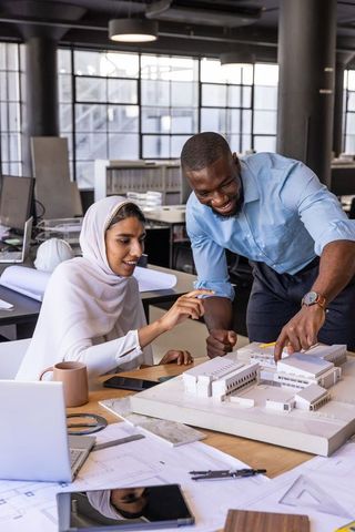 Architectural Team Collaborating on Scale Model in Office