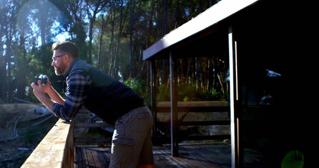 Man Enjoying Nature While Taking Photos from Wooden Cabin Deck - Download Free Stock Images Pikwizard.com