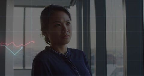 Asian Professional Woman Analyzing Data in Modern Office
