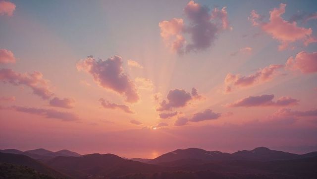 Pastel sky and rolling mountains with radiant sun rays