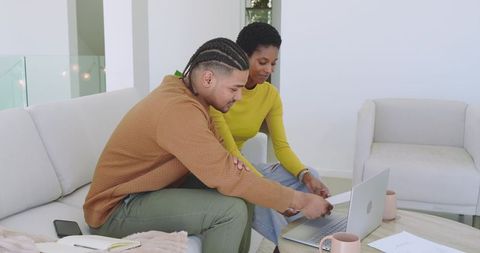 Modern Coworkers Collaborating on Laptop in Relaxed Home Environment