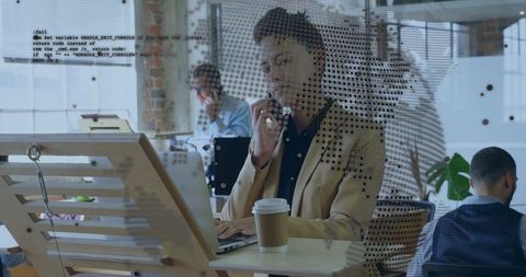 Businesswoman Balancing Mobile Call and Laptop Work in Modern Office
