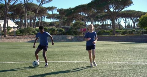 Youth soccer training practicing ball control and teamwork on turf field