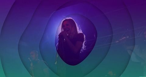 Female Vocalist Singing on Stage in Vibrant Lighting