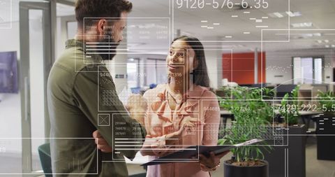 Business Professionals Analyzing Virtual Financial Data in Office