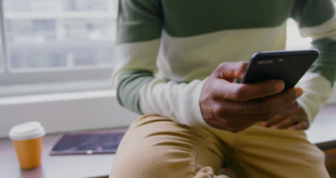 Business Professional Engaged with Smartphone in Modern Workspace