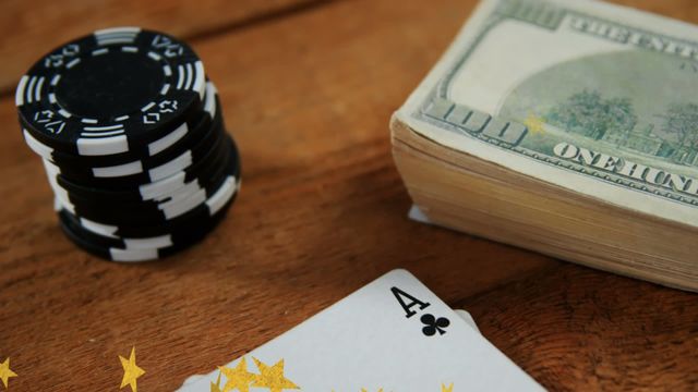 Features poker chips stacked beside a bundle of money on a wooden table, symbolizing successful gambling. Suitable for illustrating stories about casinos, gambling environments, economic winnings, online casino promotions, card games, and related financial success. Stars overlay adds a celebratory aspect to win or start of a gaming session.