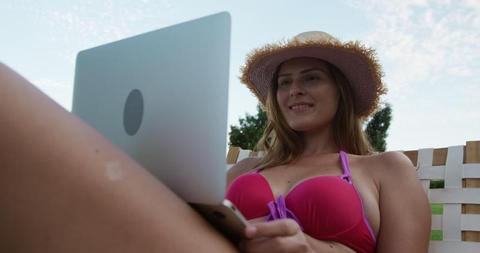 Woman in Swimsuit Relaxing Outdoors While Using Laptop - Download Free Stock Images Pikwizard.com