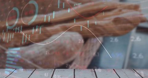 Baguettes with digital stock charts overlay on wooden table