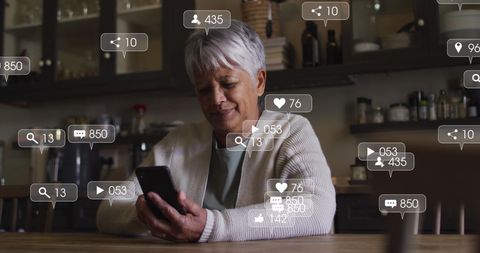 senior woman engaging with social media on smartphone at home - Download Free Stock Images Pikwizard.com