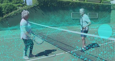 Energetic Seniors Engaging in Tennis Match on Sunny Court