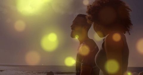 Silhouetted Couple Enjoying Sunset Beach Scenery