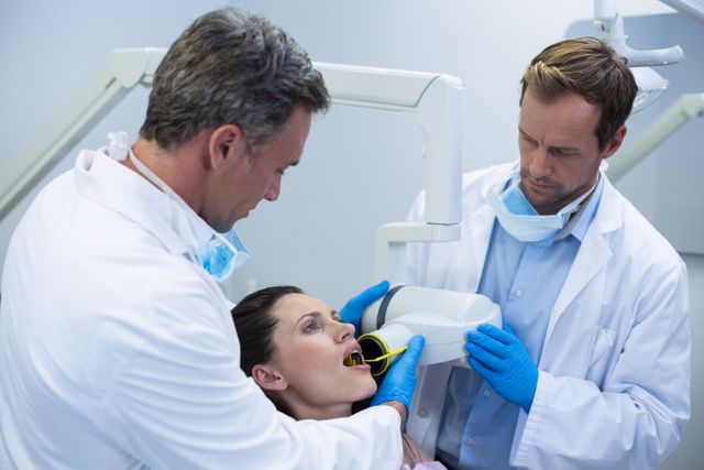 Dentists taking x-ray of patients teeth at dental clinic
