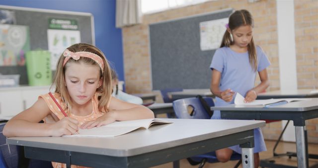 Focused Children Studying in Classroom with Natural Light - Download Free Stock Images Pikwizard.com