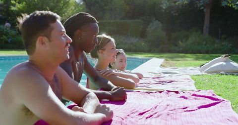 Diverse Friends Relaxing by Backyard Pool on Sunny Day