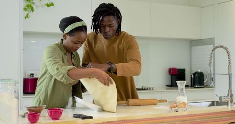 African American Couple Making Dough Together on White Kitchen Island, Weekend Baking