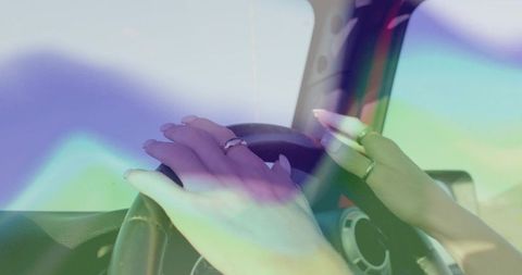 Fashionable Hands Gripping Vehicle's Steering Wheel in Motion