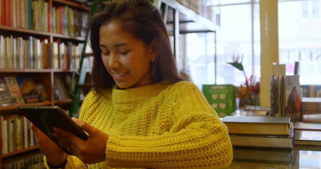 Smiling Woman Reading on Tablet in Bookstore - Download Free Stock Images Pikwizard.com