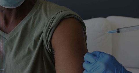 Medical Worker Administering Vaccine in Clinical Environment