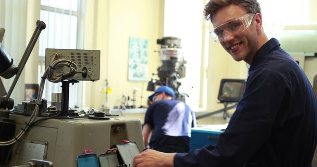 Young Engineer Smiling in Industrial Workshop - Download Free Stock Images Pikwizard.com