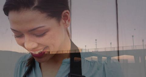 Woman smiling with evening pier reflection and tranquil ambiance