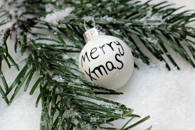 Merry Xmas Ornament on Snow-Covered Pine Needles - Download Free Stock Photos Pikwizard.com