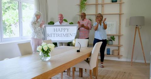 Older adults celebrating retirement gathering with banner and smiles