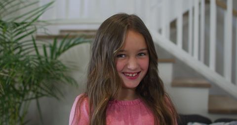 Smiling Young Girl with Long Hair Indoors