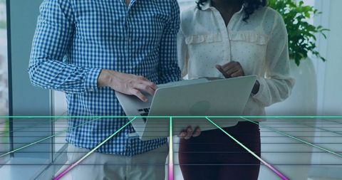 Collaborative Teamwork with Laptop and Futuristic Neon Grid