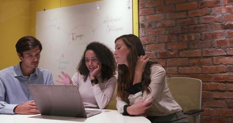 Young Professionals Engaged in Creative Meeting in Modern Office