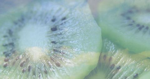Close-up of Overlapping Kiwi Slices with Glossy Texture