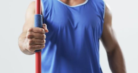 Athlete holding javelin highlighting fitness dedication