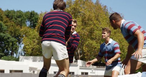 Young Caucasian Men Competing in Intense Rugby Match Outdoors - Download Free Stock Images Pikwizard.com
