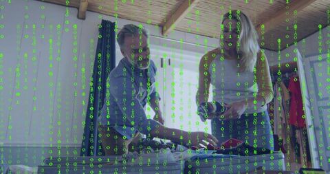 Couple packing suitcase at home with green binary code overlay symbolizing digital security