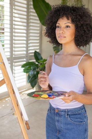 Creative Female Painter in Natural Light-Filled Studio Environment