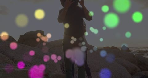 Glowing Light Spots Over Couple on Beach Sunset