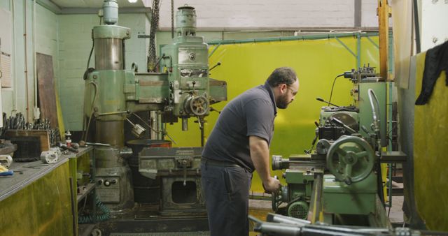 Male Worker Operating Industrial Machinery in Metal Workshop - Download Free Stock Images Pikwizard.com