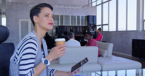 Businesswoman Enjoying Coffee and Tablet in Modern Office - Download Free Stock Images Pikwizard.com