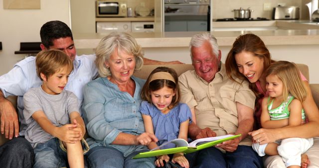 Happy multigenerational family reading on couch together at home - Download Free Stock Images Pikwizard.com