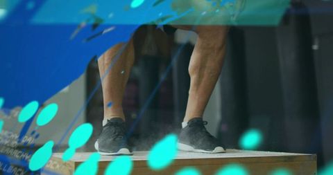 Balancing athlete pressing on plyo box highlighting calves ankles and stability