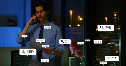 Working late in office multitasking with phone and document amid floating notifications